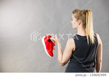 Woman presenting sportswear trainers shoes Woman presenting sportswear trainers shoes 138692999