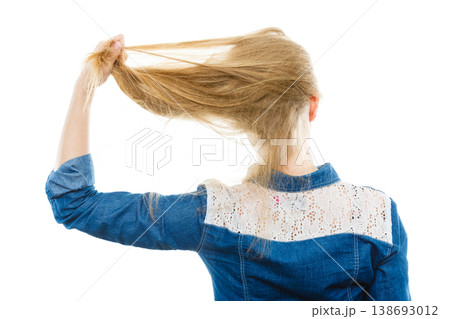Blonde woman playing with hair. Blonde woman playing with hair. 138693012