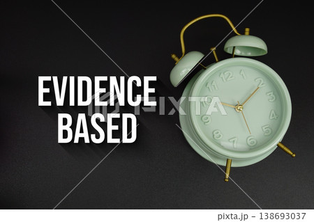 Evidence Based text with alarm clock on black background Evidence Based text with alarm clock on black background 138693037