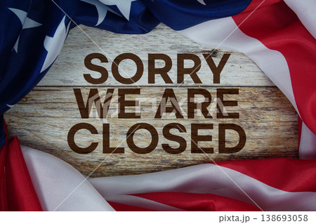American flag with "Sorry We're Closed" on wooden background 138693058