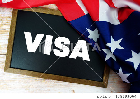 American flag with blackboard "VISA" on wooden background American flag with blackboard "VISA" on wooden background 138693064