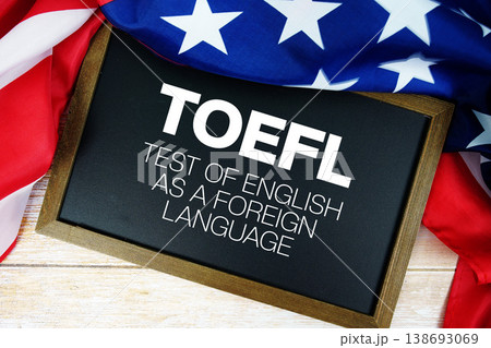 American flag with blackboard  "TOEFL" on wooden background 138693069