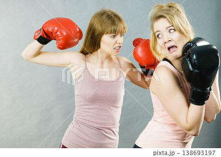 Woman being punched by box friend 138693197