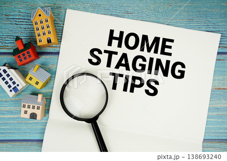 Notepad with "Home Staging Tips" with magnifying glass and house model on wooden background Notepad with "Home Staging Tips" with magnifying glass and house model on wooden background 138693240