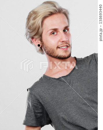 Happy smiling blonde man in grey t shirt Happy smiling blonde man in grey t shirt 138693440