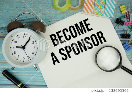 Become A Sponsor text written on notepad with alarm clock and magnifying glass flat lay on wooden background 138693562