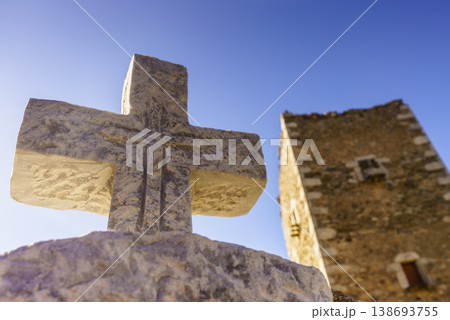 Greek stone cross and tower house, Greece Greek stone cross and tower house, Greece 138693755