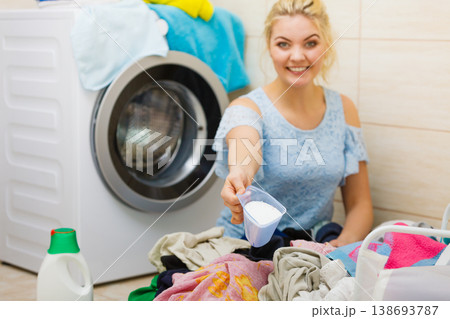 Woman wash laundry using powder detergent Woman wash laundry using powder detergent 138693787
