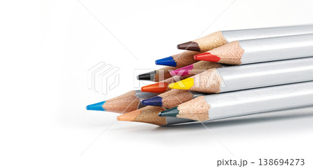Silver-barreled colored pencils stacked horizontally with clean white copy space to the left Silver-barreled colored pencils stacked horizontally with clean white copy space to the left 138694273
