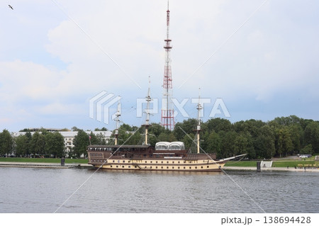 Vintage tall ship with detailed rigging and surrounding modern structures Vintage tall ship with detailed rigging and surrounding modern structures 138694428