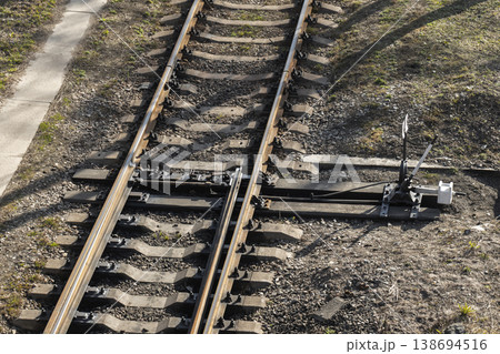 Railway switch and train tracks converge on gravel ballast 138694516