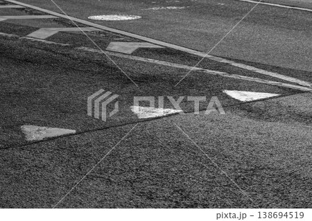 High-contrast black and white photo of asphalt pavement 138694519