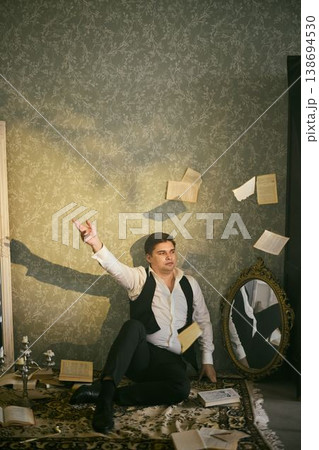 Vintage magician with floating pages and ornate background 138694530