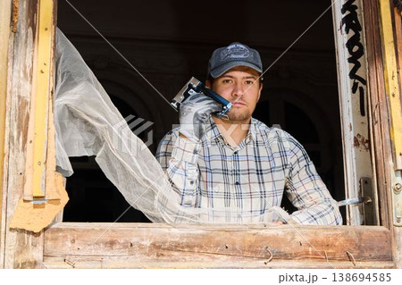 Trade professional standing firm amidst renovation surroundings 138694585