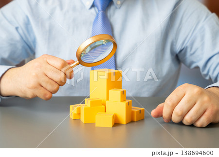 A man examines imported goods. Customs inspection. Combating smuggling and tax evasion schemes. Quality control ensures compliance, safety standards and fair international trade practices. A man examines imported goods. Customs inspection. Combating smuggling and tax evasion schemes. Quality control ensures compliance, safety standards and fair international trade practices. 138694600