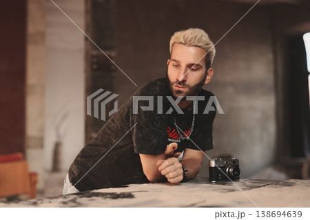 Focused white camera technician testing vintage camera 138694639