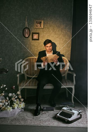 Male individual contemplating personal correspondence ambiance 138694647