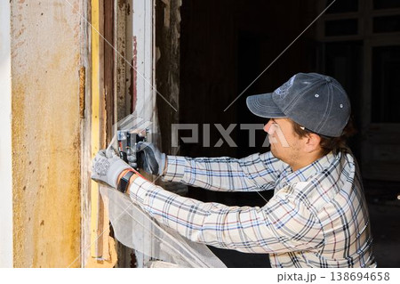 Expert employing cordless sander to achieve smooth window frame surfaces Expert employing cordless sander to achieve smooth window frame surfaces 138694658
