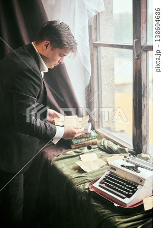 Committed researcher categorizes vintage documents carefully 138694686