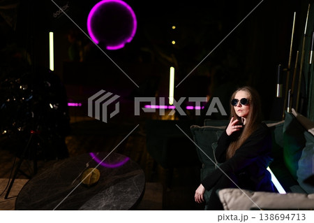 Casual female founder studying in vibrant city lounge ambiance Casual female founder studying in vibrant city lounge ambiance 138694713