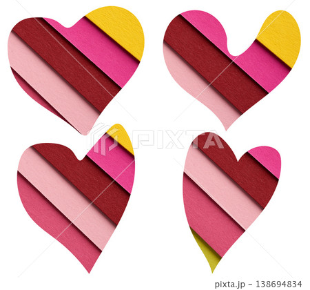 A set of decorative hearts of varying shapes, composed of diagonal layers of textured paper in pink and yellow tones A set of decorative hearts of varying shapes, composed of diagonal layers of textured paper in pink and yellow tones 138694834