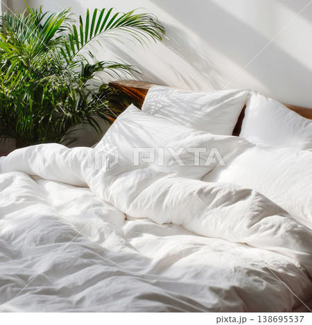 Cozy Sunlit Bed with Green Plant 138695537