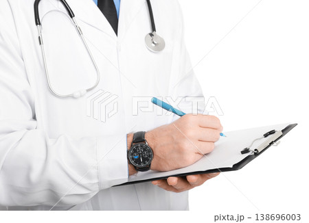 male doctor writing medical notes on a clipboard. Professional physician in white lab coat with stethoscope isolated on white background. Copy space. 138696003