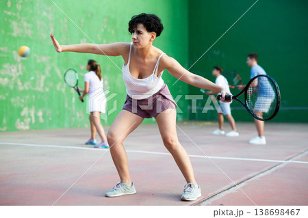 Woman playing frontenis on outdoor pelota court Woman playing frontenis on outdoor pelota court 138698467