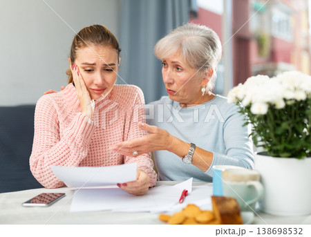 Young woman with financial problems and her mother at home Young woman with financial problems and her mother at home 138698532
