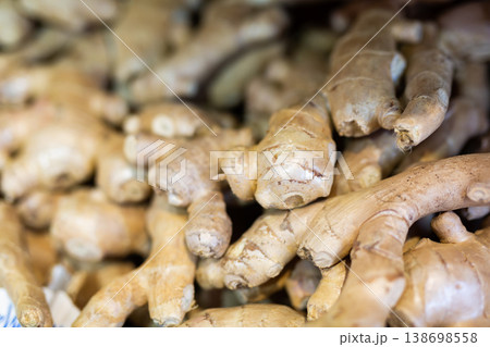 Ginger root on showcase of greengrocery shop for sale to customers Ginger root on showcase of greengrocery shop for sale to customers 138698558