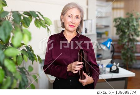 Positive mature woman working at office 138698574