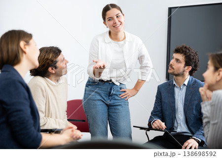 Young female teacher giving lecture to group of student Young female teacher giving lecture to group of student 138698592