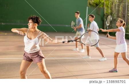 Woman serving ball during frontenis game outdoors 138698701