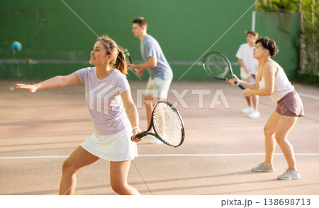 Woman playing frontenis on outdoor pelota court 138698713