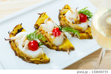 Sepia fried on a grill with pineapple and cherry tomatoes is tasty dish 138698735
