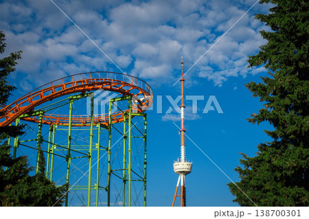 Dramatic low angle of a roller coaster loop with fluffy altocumulus clouds Dramatic low angle of a roller coaster loop with fluffy altocumulus clouds 138700301