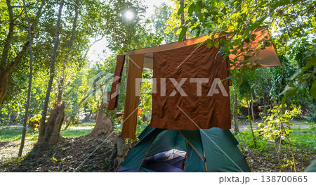 Forest tents, hanging robes and shaded paths create a clear retreat backdrop. The natural scene suits meditation and religion content. Forest tents, hanging robes and shaded paths create a clear retreat backdrop. The natural scene suits meditation and religion content. 138700665