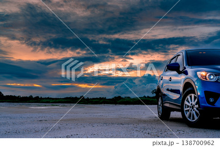Luxury blue SUV car parked on land beside tropical forest with beautiful sunrise sky. New car with sport and modern design. Car drive for adventure road trip. Nature landscape. Automotive industry. Luxury blue SUV car parked on land beside tropical forest with beautiful sunrise sky. New car with sport and modern design. Car drive for adventure road trip. Nature landscape. Automotive industry. 138700962