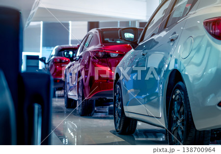 Rear view of new luxury red and white car parked in modern show room. Selective focus on white shiny car. Car dealership concept. Showroom interior. Automotive industry on coronavirus crisis concept. 138700964