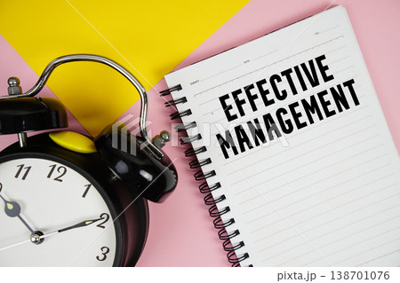 Effective Management text written on notepad with alarm clock on pink background Effective Management text written on notepad with alarm clock on pink background 138701076