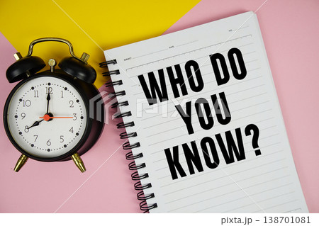 Who Do You Know? text written on notepad with alarm clock on pink background Who Do You Know? text written on notepad with alarm clock on pink background 138701081