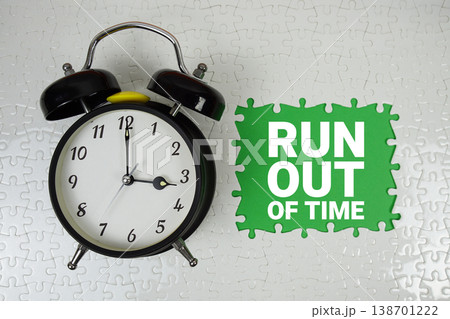 Run out of time text with alarm clock on green background 138701222