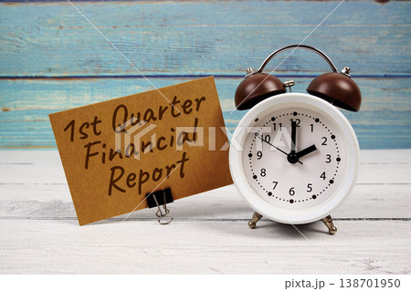 1st Quarter Financial Report text written on paper card with alarm clock on wooden background 1st Quarter Financial Report text written on paper card with alarm clock on wooden background 138701950