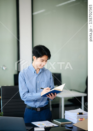 Confident  Asian businessman typing laptop computer and digital tablet at office 138702565