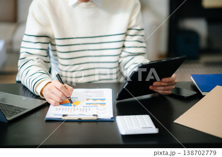 Businesswoman hand using laptop, tablet and smartphone in office. Digital marketing media mobile app Businesswoman hand using laptop, tablet and smartphone in office. Digital marketing media mobile app 138702779
