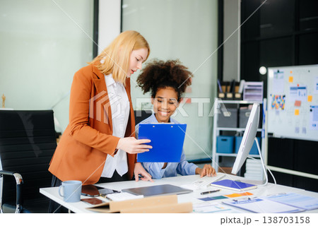 Female discussing new project with male colleague. Young woman talking 138703158