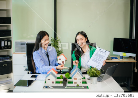 Signing a contract. Client and broker agent, lease agreement, successful deal and Young business sitting Signing a contract. Client and broker agent, lease agreement, successful deal and Young business sitting 138703693