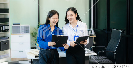 Two Asian businesswoman and man discuss investment project working and planning strategy Two Asian businesswoman and man discuss investment project working and planning strategy 138703775