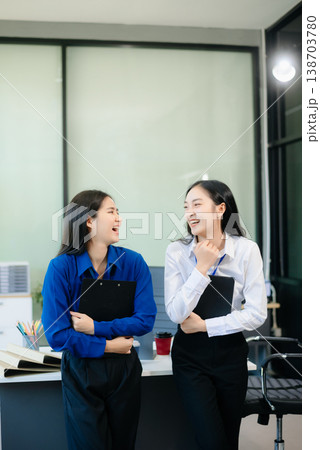 Two Asian businesswoman and man discuss investment project working and planning strategy Two Asian businesswoman and man discuss investment project working and planning strategy 138703780