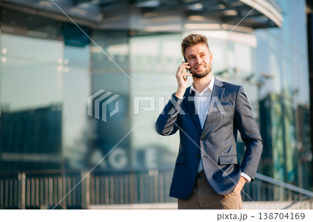 Successful Businessman in suit using tablet outdoors. Perfect for corporate, technology, and professional themes 138704169
